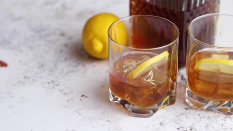 whiskey sour drink with lemon in glass on stone rustical background