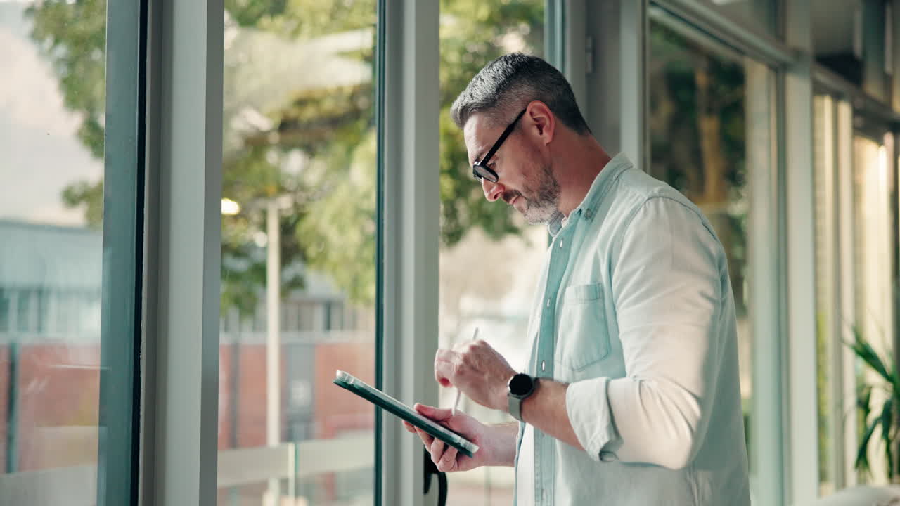 Man with Tablet by Window