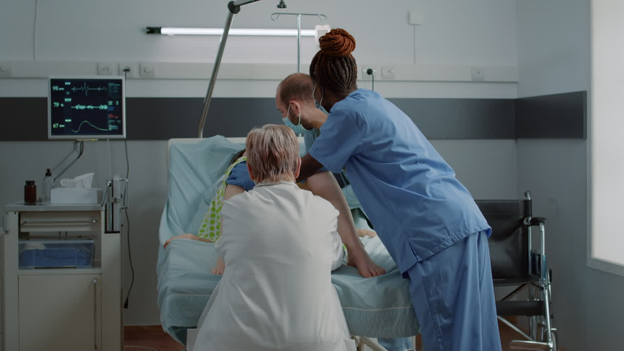 Close up of multi ethnic medical team helping childbirth