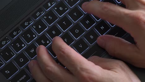 View-from-above-of-hand-typing-on-laptop