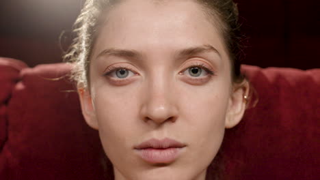 Close-Up-View-Of-Blonde-Woman-Looking-At-Camera-Sitting-In-The-Cinema