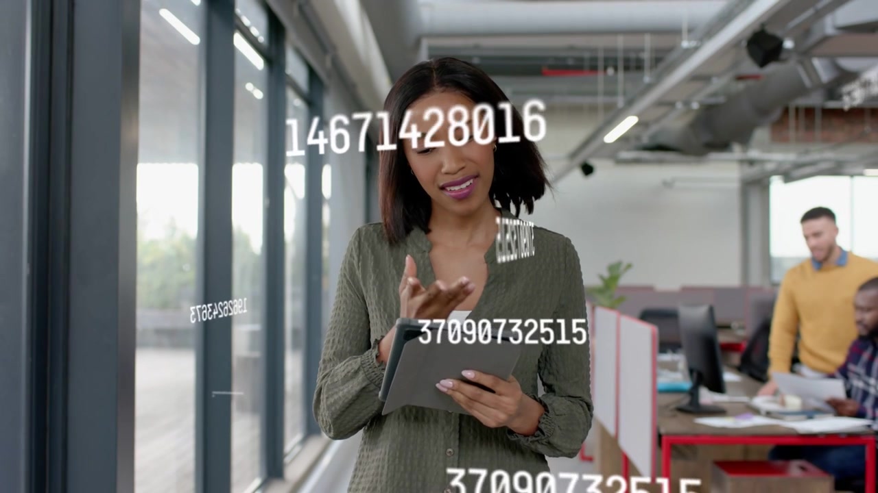 Woman scrolling tablet near windows, floating numbers appearing, analyzing sales, colleague nearby