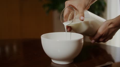 pouring milk into a bowl