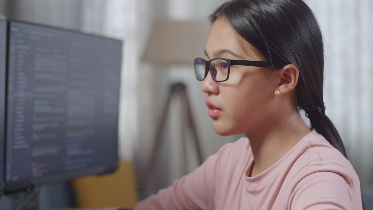 Teenage Girl Concentrating on Computer Code