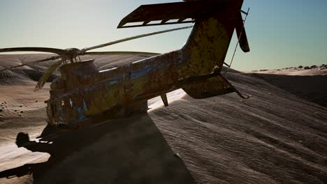 old-rusted-military-helicopter-in-the-desert-at-sunset