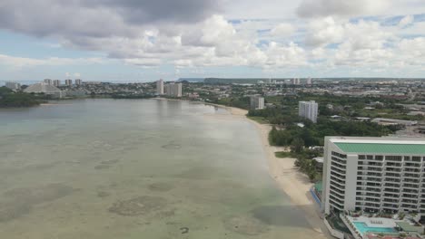 Drone-flying-down-the-coastline-of-Guam-towards-Tumon