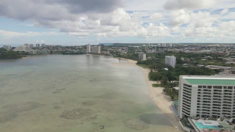 drone flying down the coastline of guam towards tumon