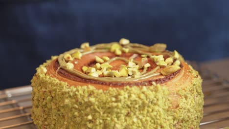 pistachio donut being decorated dried raspberry