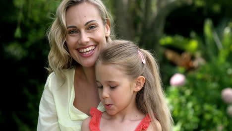 portrait of cute mother and daughter are looking the camera and smiling