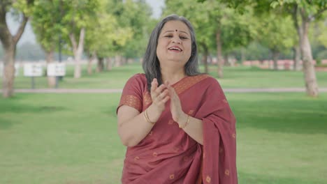 Happy-Indian-old-woman-clapping-and-appreciating-in-park