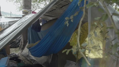 refugee camp: improvised shelter and hammock