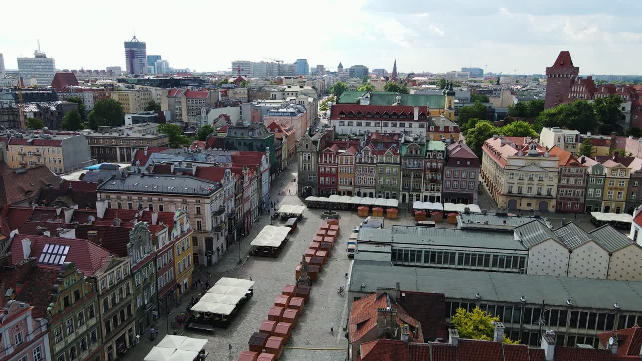 Colorful buildings and market stalls fill the square in vibrant Poznan, Poland