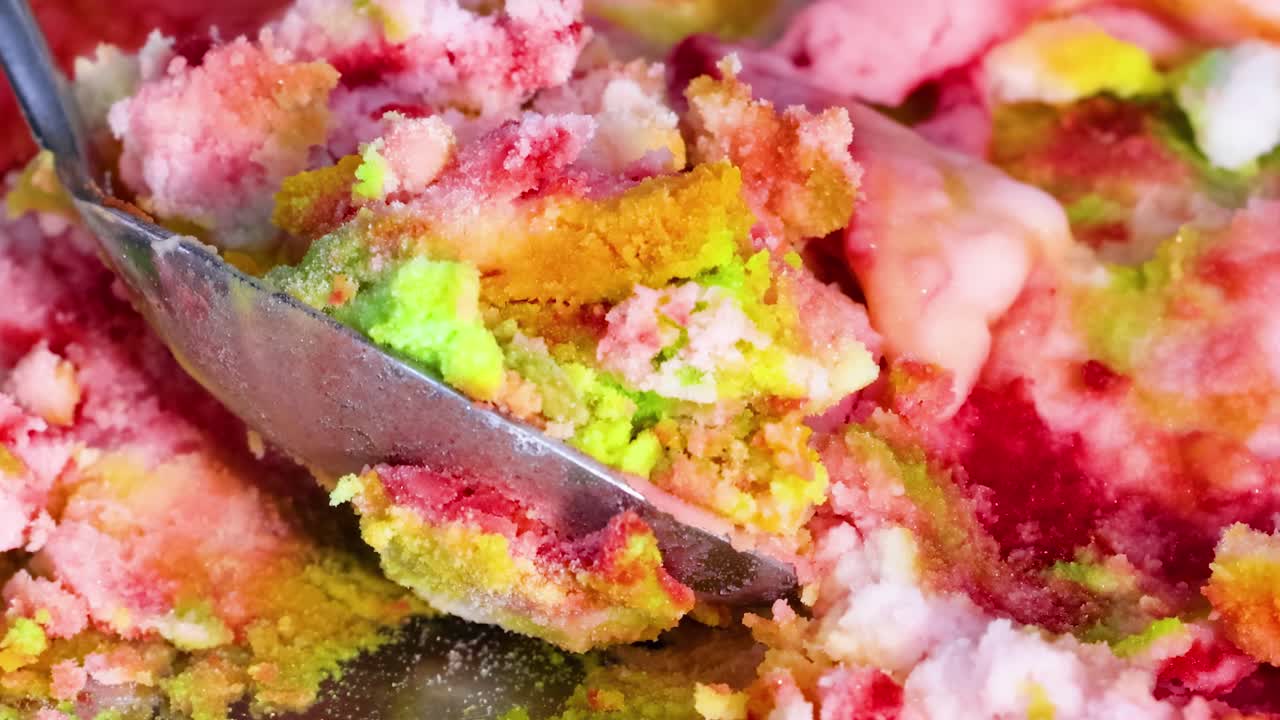 Explore the vivid textures and colors as a spoon mixes a colorful concoction.