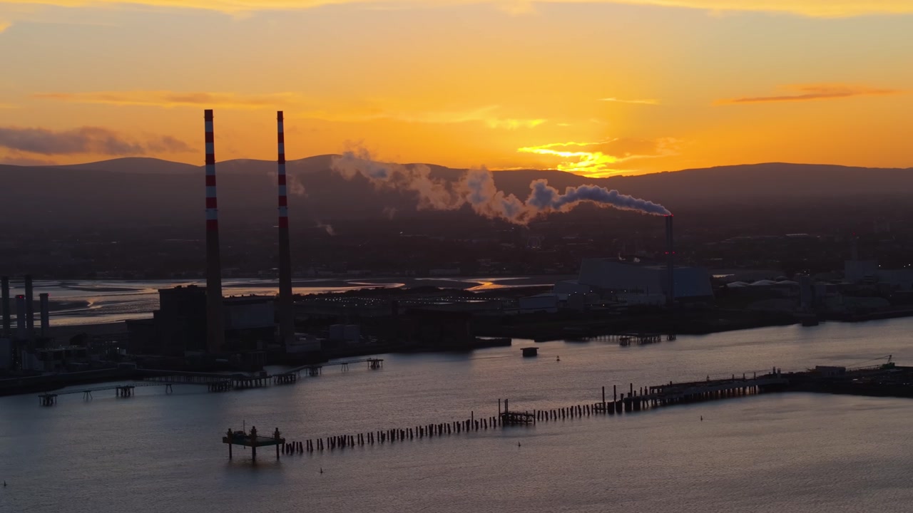 4K cinematic drone footage showcasing Poolbeg Lighthouse in Dublin during a breathtaking golden-hour sunset_12