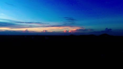 Drone-shot-flying-up-and-panning-across-a-sunset-sky