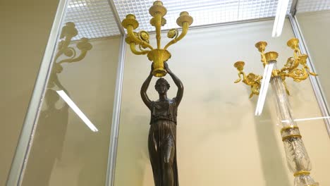 antique candelabra and statues on display