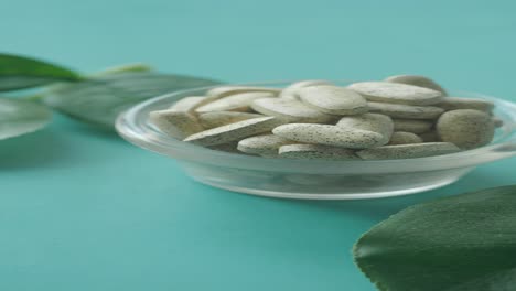 healthy supplements in a glass bowl with leaves