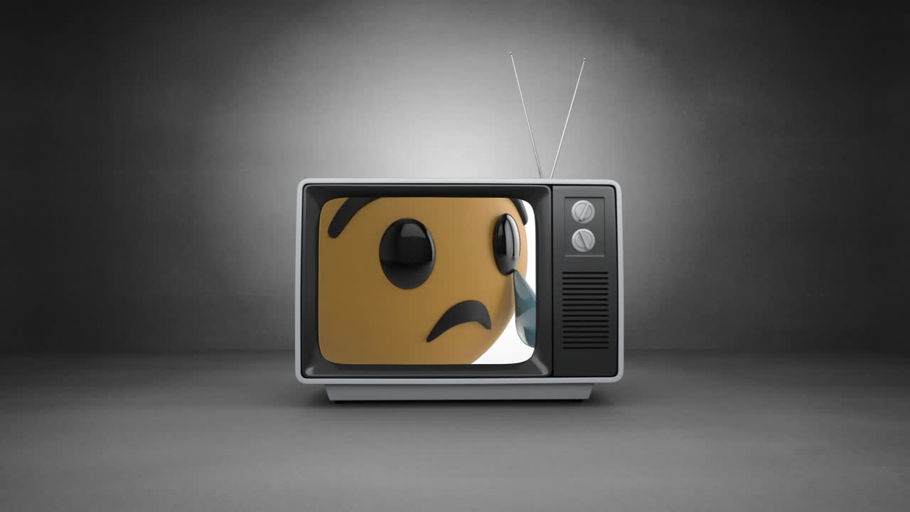 Digital animation of crying face emoji on television screen against grey background
