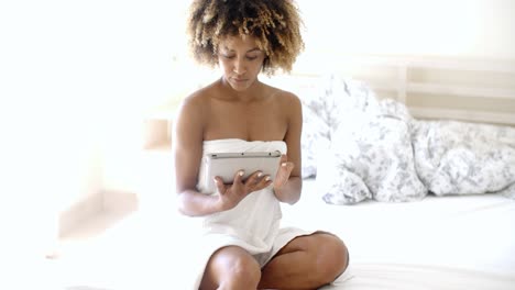 Young-Woman-Using-Tablet-On-Bed