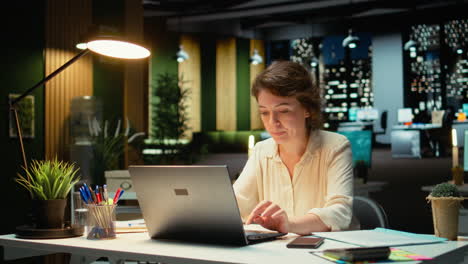 vertical video woman finishes methodical planning after hours and closes the lamp