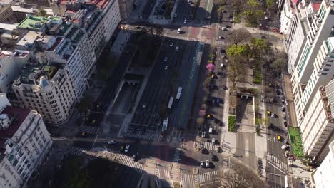 Aerial-birds-eye-shot-of-busy-9-De-Julio-Avenue-with-cars,bus-and-taxi-during-sunlight-in-Buenos-Aires---Air-Pollution-of-car-fumes-in-downtown