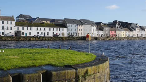 establishing shot of galway city center featuring the long walk on a sunny day