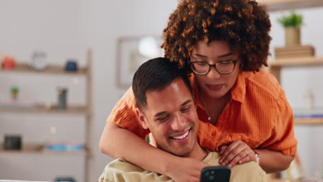 Hug,-social-media-and-happy-couple-on-sofa