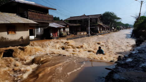flooded village street with person