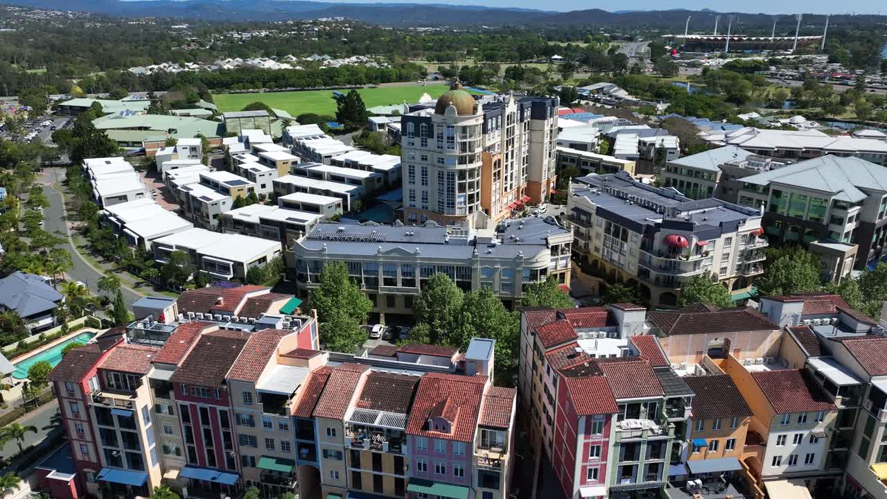 The Village at Emerald Lakes features picturesque views with Carrara Stadium visible in the distance, offering a scenic and vibrant setting for residents and visitors alike.