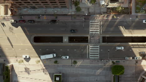 Slow-Rise-up-above-Downtown-street-of-Los-Angeles,-California-in-beautiful-Sunset-Golden-Hour-light,-Aerial-Birds-Eye-View-Overhead-Top-Down-View