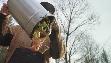 240fps slow motion hipster woman pours colourful food waste scraps out of a bucket