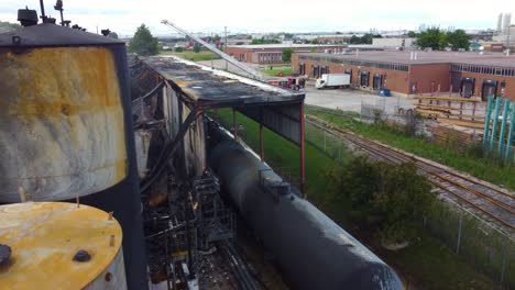 Destroyed-factory-and-wagons,-massive-industrial-fire-in-Toronto,-Canada,-aerial