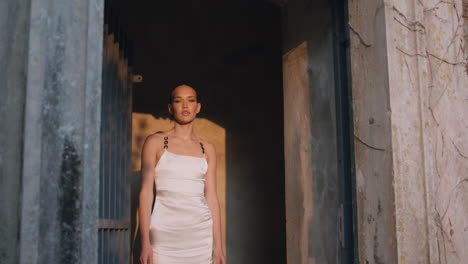 glamorous woman walking ancient palace in white dress. gorgeous lady posing