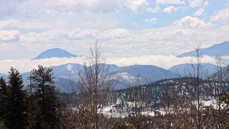 low clouds building during a timelapse during the spring with snow on the ground, viewing the lost creek wilderness and green mountain in the pike national forest in the rock mountains, colorado, usa