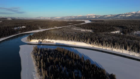 drone flight over lake laberge during winter in yukon, canada