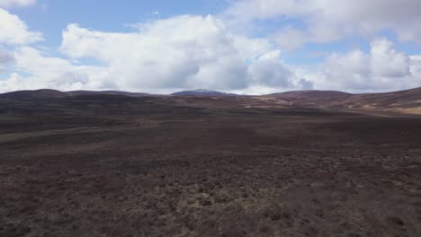 Aerial-flying-forward-over-plain-in-The-Cairngorms,-Scotland