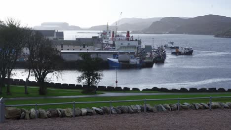 Shot-of-fishing-boats-moving-around-a-harbour-and-pier