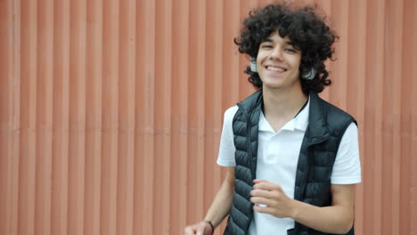 happy teenager dancing with headphones
