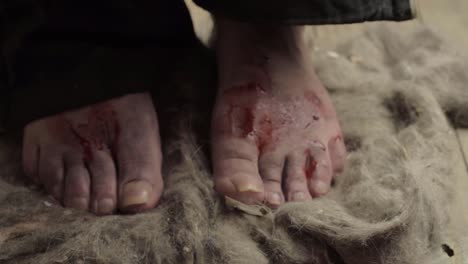 desperate dirty bloody bare feet walking on dusty floor