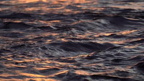 ocean waves in evening at sunset with bright reflections