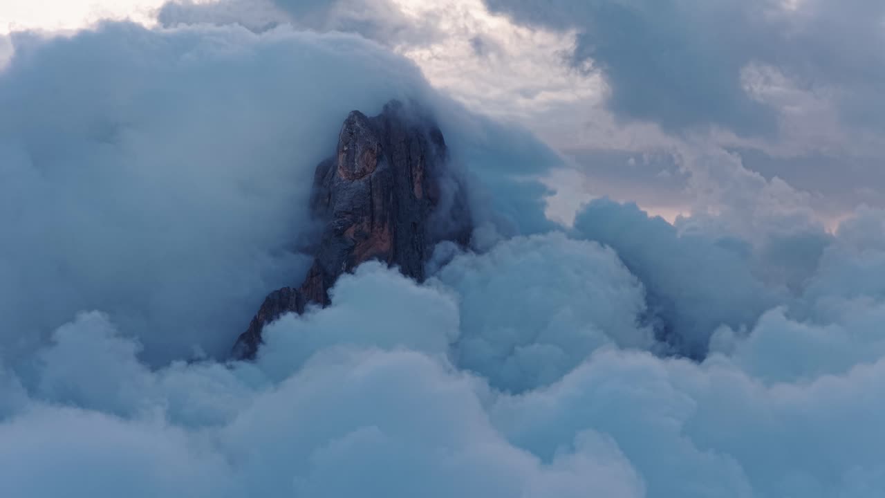 Misty peak of Cimon de la Pala, Dolomites, at dawn in a calm atmosphere