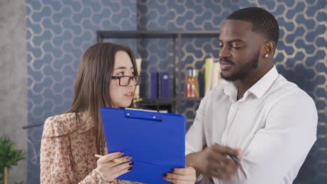 close-up of multiethnic colleagues working together in office.