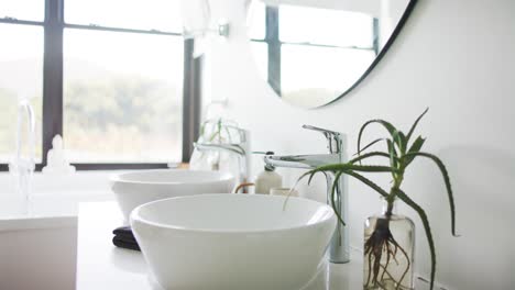 close up of washbasin and mirror in bathroom, slow motion