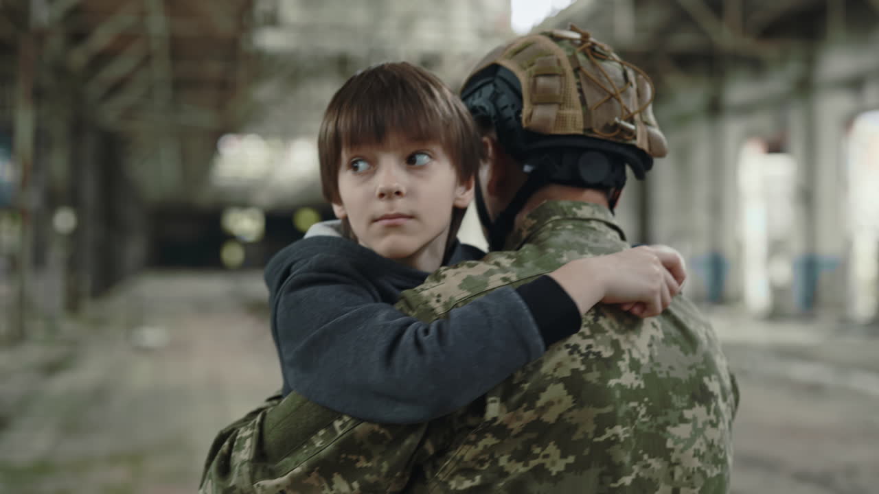 Soldier Carrying a Child in a War Zone
