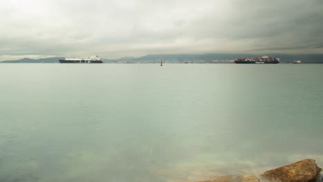 Sea-level-shot-of-moored-vessel-and-harbor-of-Gibraltar,-time-lapse