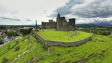 Aerial-drone-shot-of-castle-and-grassy-landscapes-in-Ireland