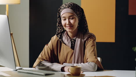 middle eastern muslim woman posing in office