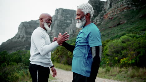 two elderly men greeting each other on a trail