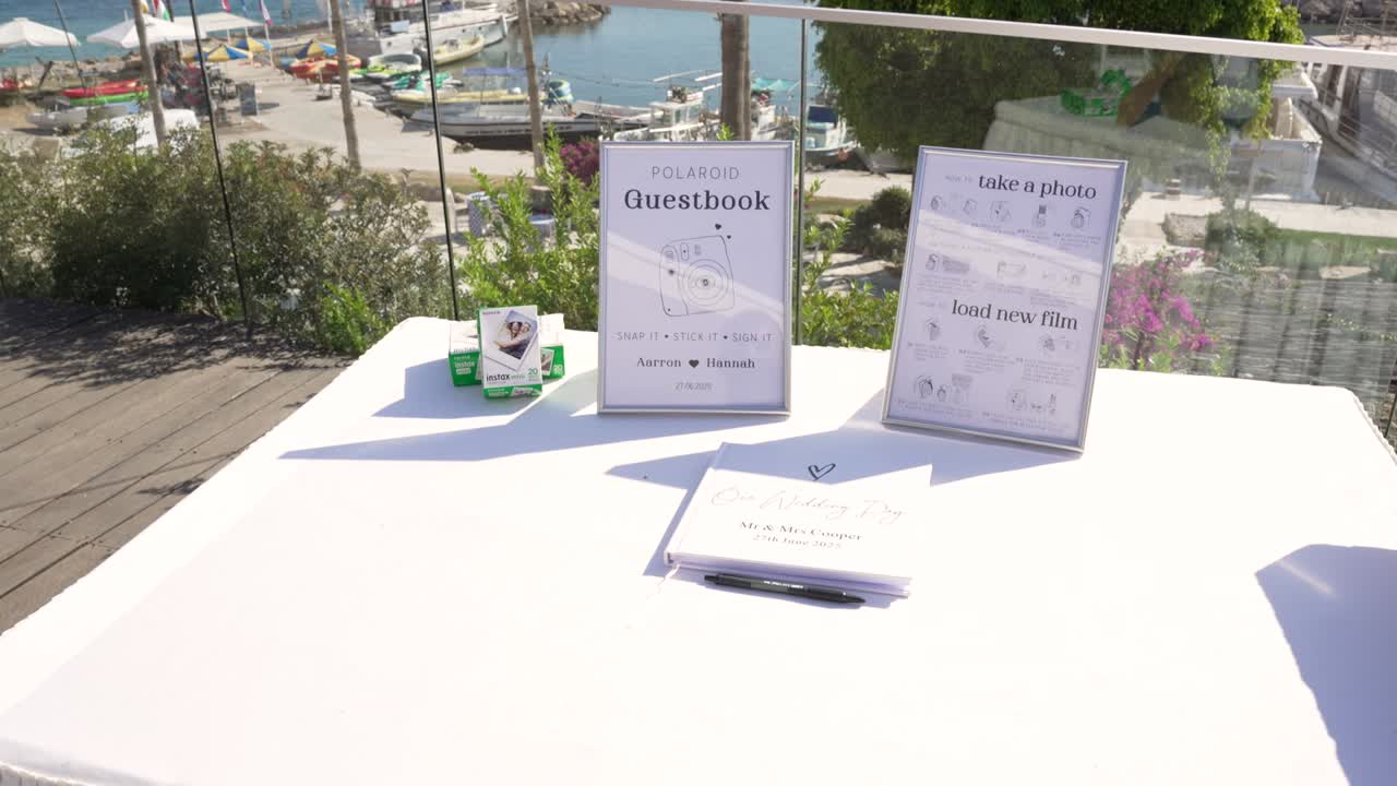 An inviting outdoor area by the marina features a guestbook and an instant photo station. Guests can leave messages and capture memories while enjoying lovely views
