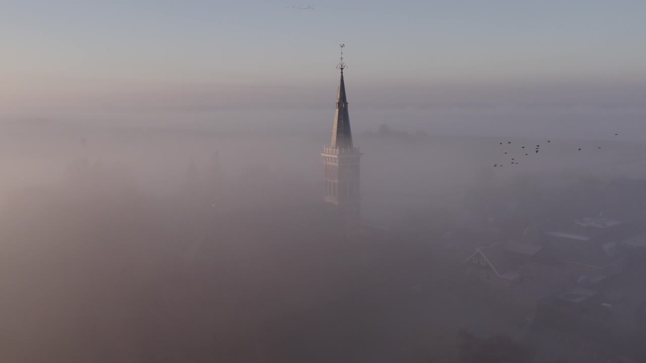 la iglesia de cornwerder en la provincia de friesland en la densa niebla matutina, aérea